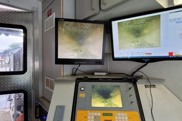 Multiple monitor screens showing CCTV inspection footage in a Muller Van.