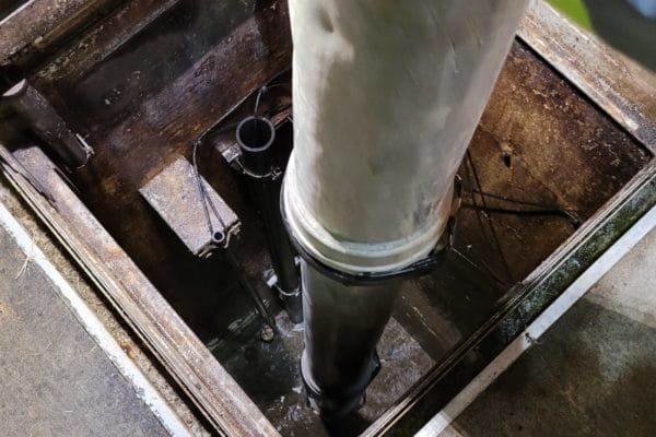 Vault beneath the surface with a large vacuum tube cleaning it out.